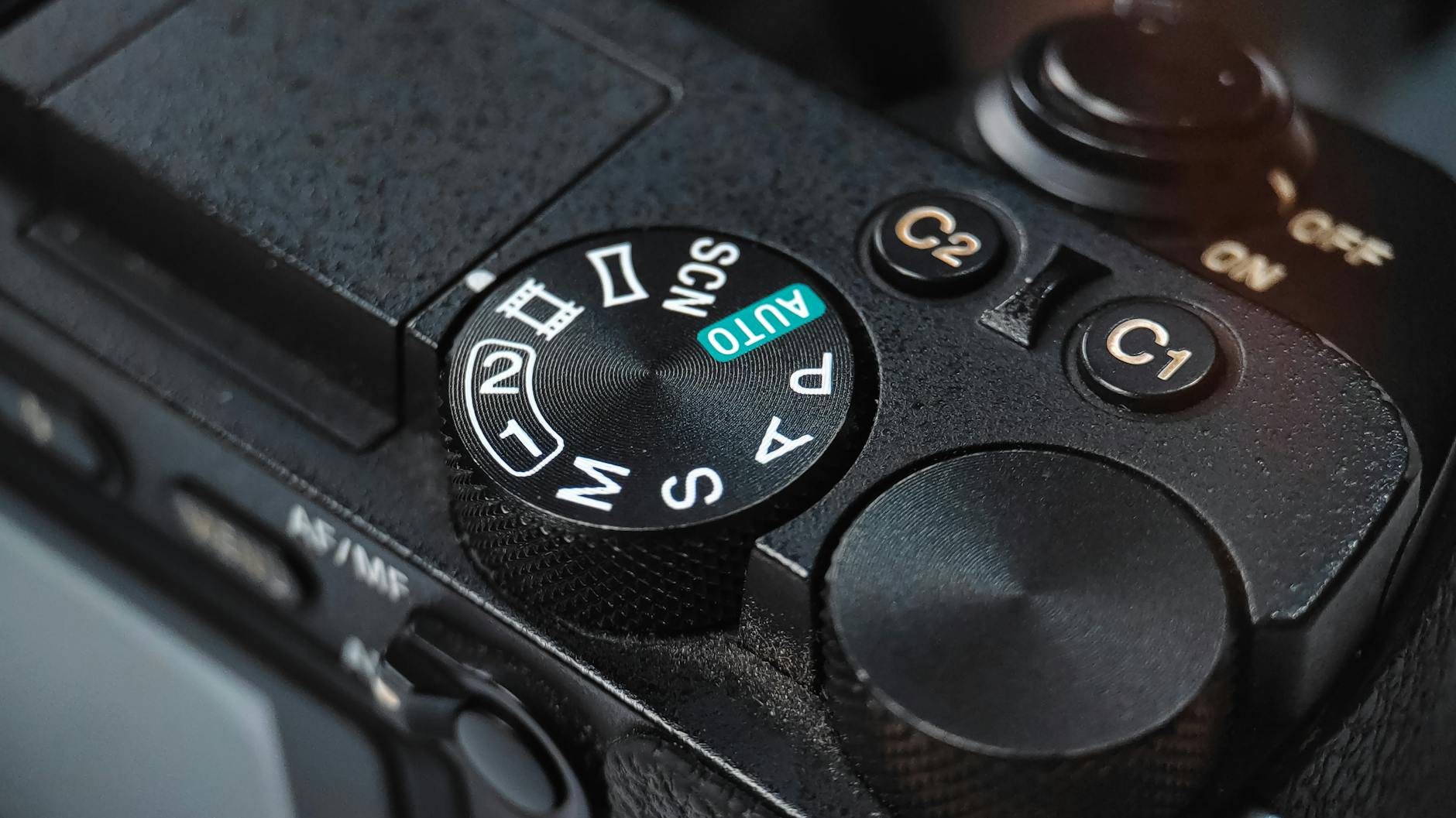 Detailed view of a DSLR camera mode dial showcasing various shooting settings.