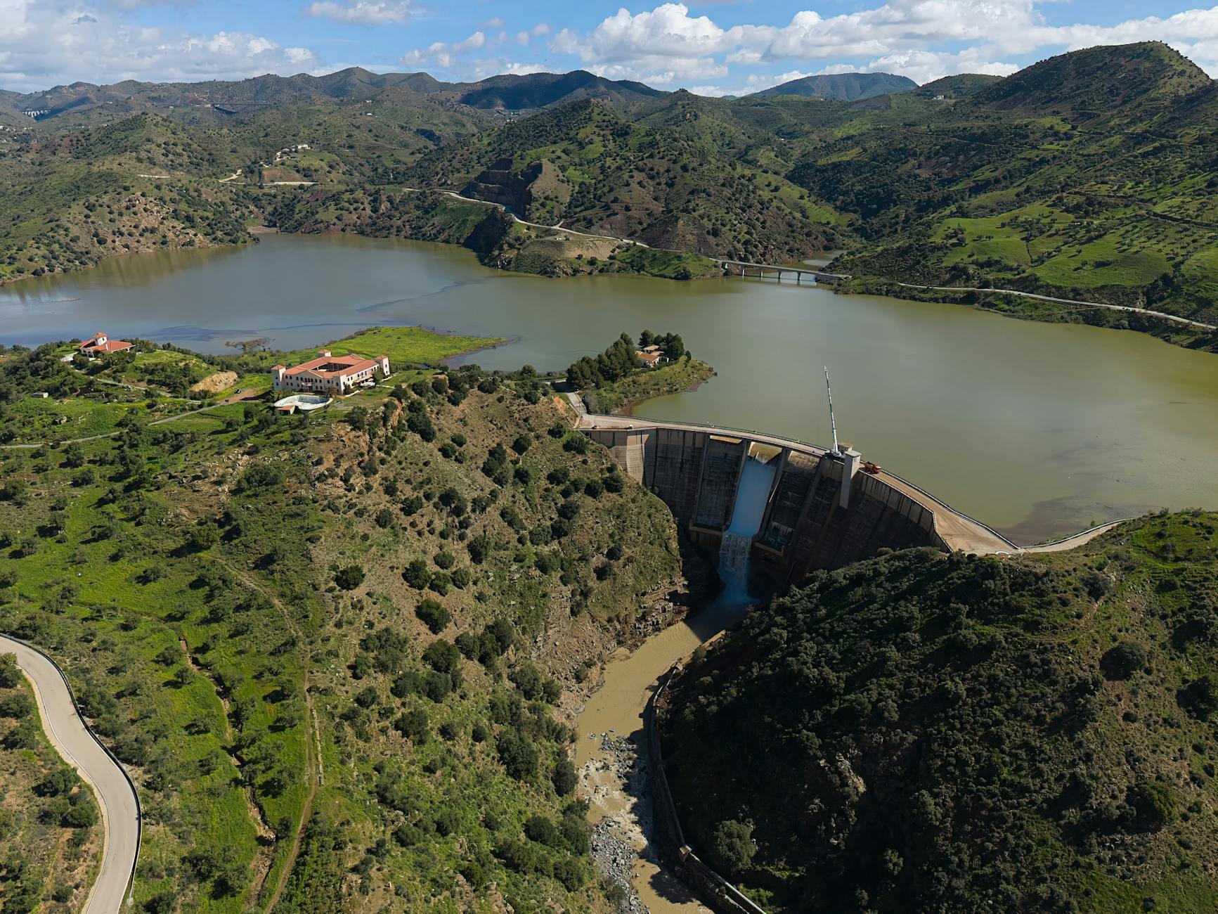 Stunning aerial view of Casasola Dam surrounded by lush landscapes in Almogía, Andalucía, Spain.