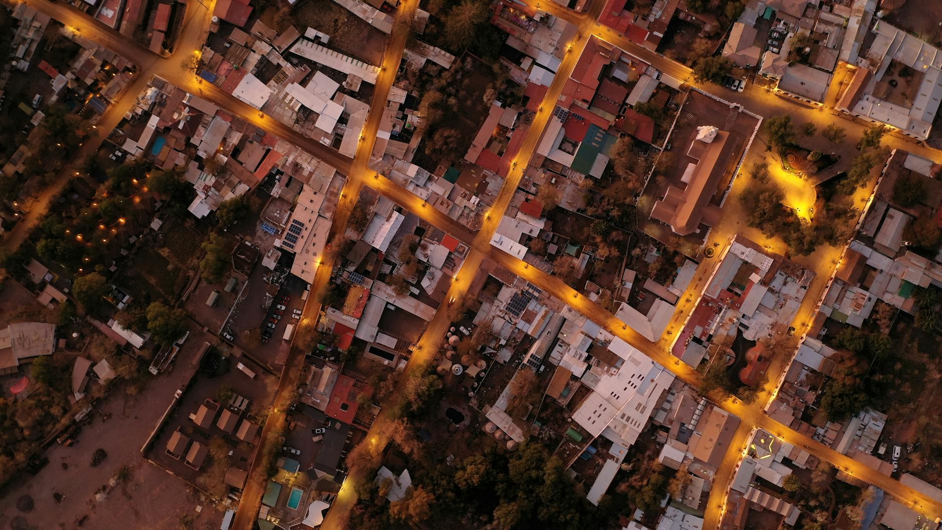 Illuminated aerial cityscape of San Pedro de Atacama, showcasing street lights and urban layout at night.