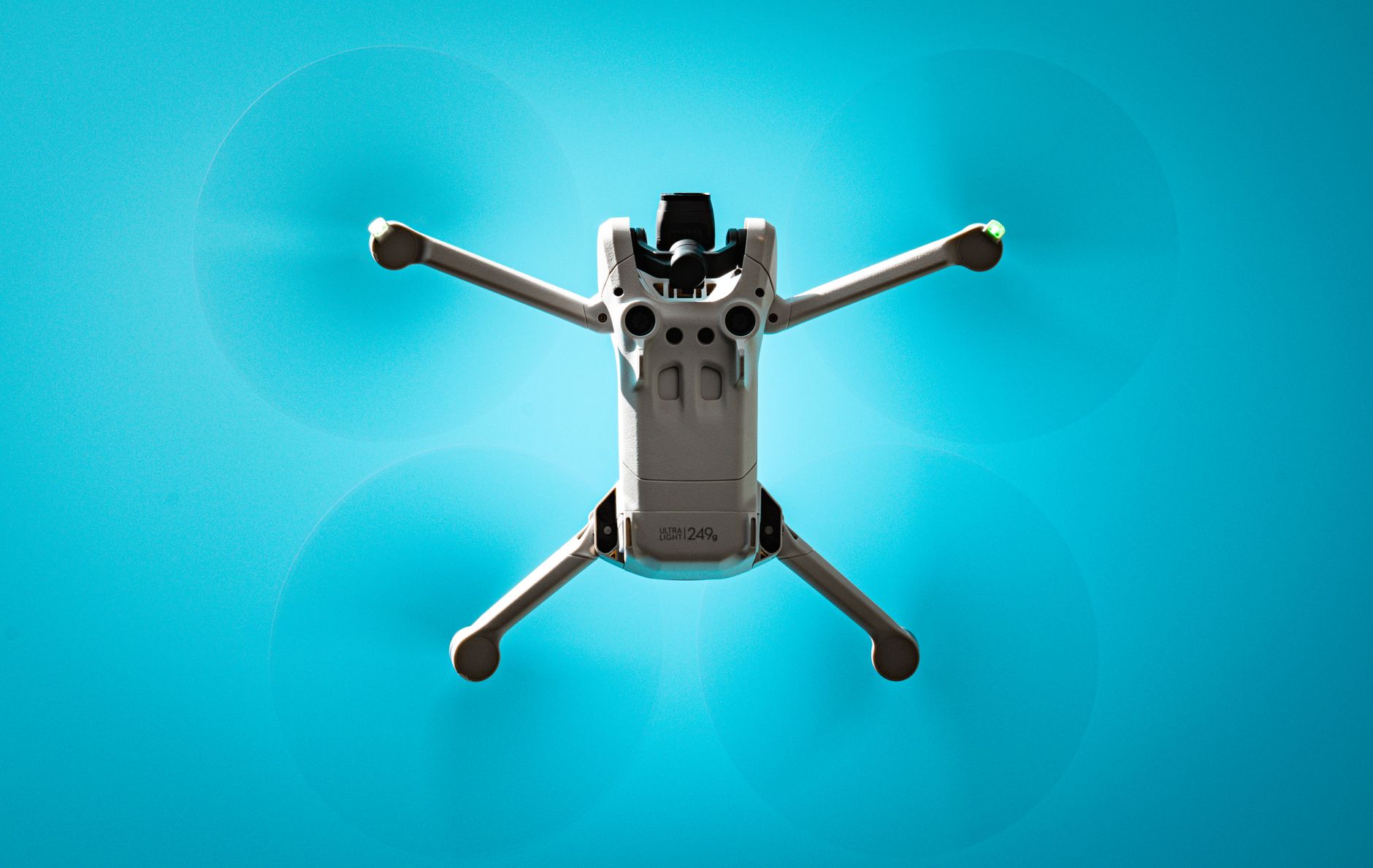 Aerial view of a drone flying against a vibrant blue sky, showcasing modern technology.