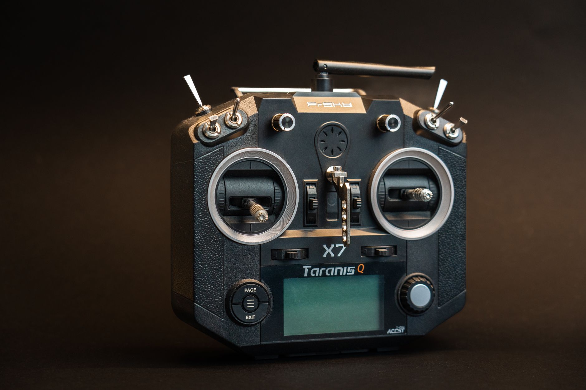 Black Taranis Q X7 drone controller with buttons and screen in a studio shot.