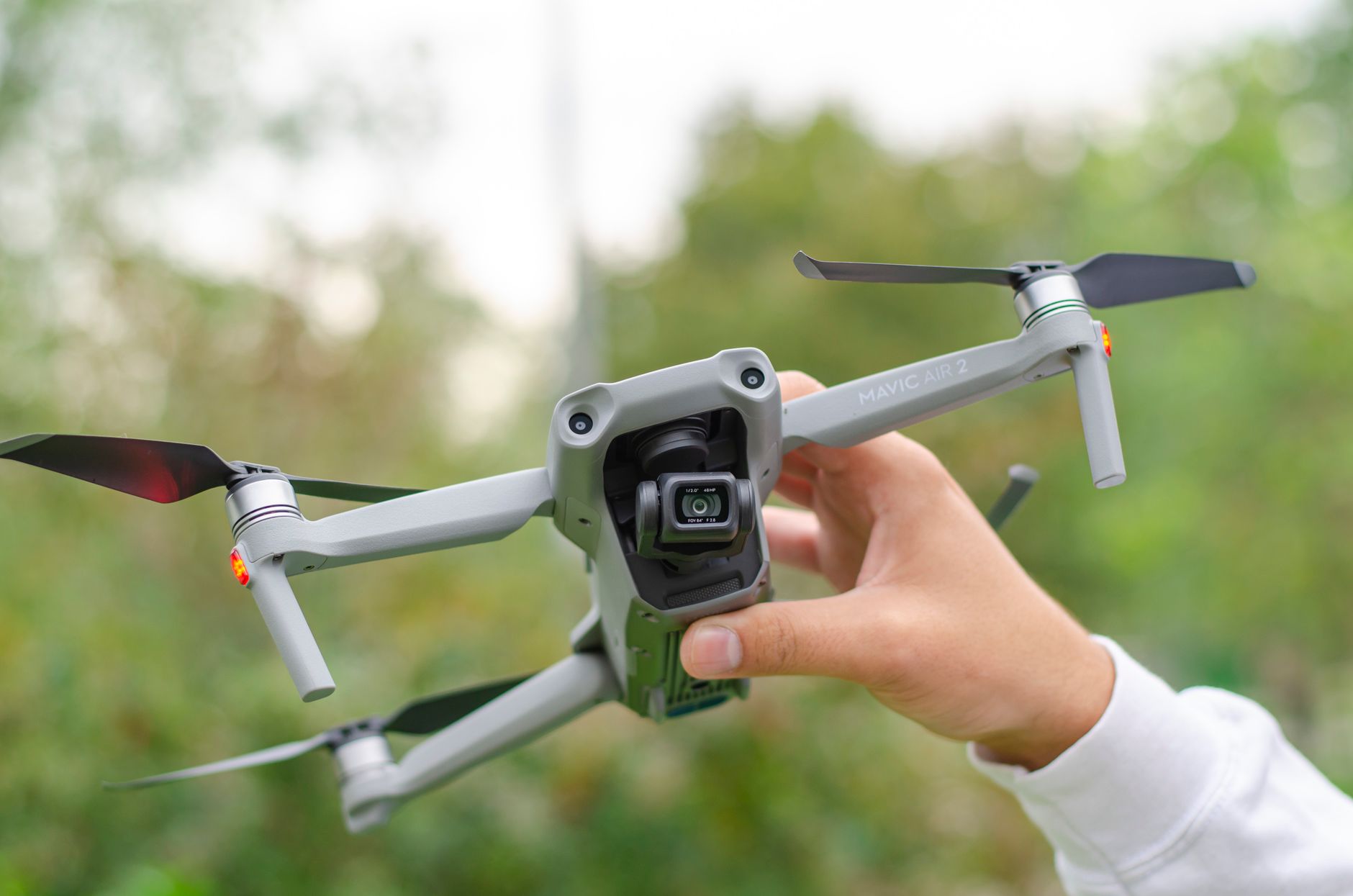 Close-up of a Mavic Air 2 drone being held outdoors. Perfect for technology and drone enthusiasts.